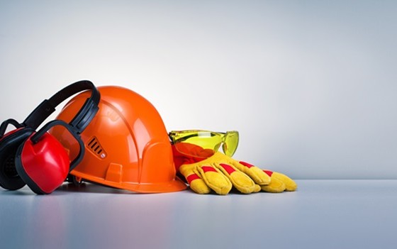 Work safety protection equipment on grey background with copy space. Horizontal banner.